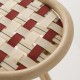 Detail of woven straps seat in Ecaille beige and Brique red of the VIRAGE design rattan barstool