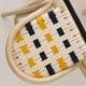 Seat detail of the VIRAGE design rattan barstool with Gendarme blue and Bouton d'Or yellow woven straps
